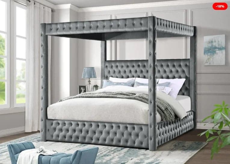 Luxurious gray upholstered canopy bed with mirrored panels and tufted headboard in modern bedroom setting