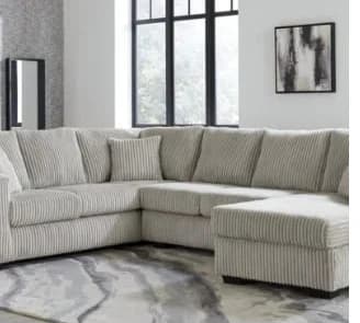 L181 Tate light grey sectional sofa in living room with discount badge