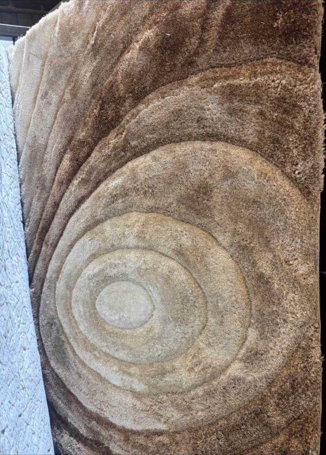 Stone architectural detail with concentric circular carved patterns in beige and brown tones