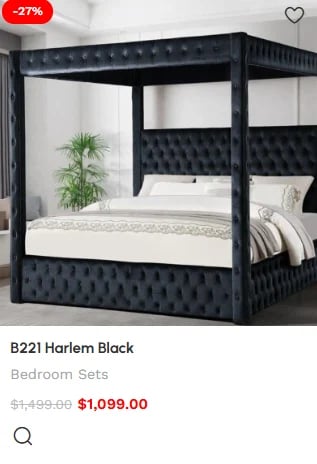 Black canopy bed with tufted upholstered headboard and frame, shown with white bedding and green plant accessory