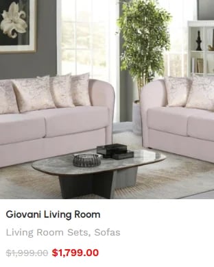Giovani Living Room set featuring two pale beige sofas with decorative pillows, black oval coffee table, and modern decor in a bright living space.
