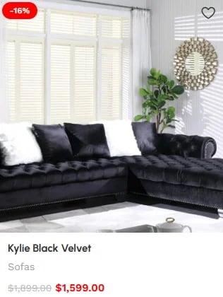 Black velvet L-shaped sectional sofa with pillows in bright living room, 16% off sale price $1,599
