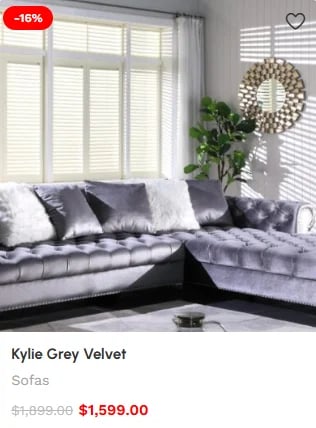 Grey velvet corner sofa in modern living room with large windows, decorative pillows, and wall decor. Product on sale for $1,599.00