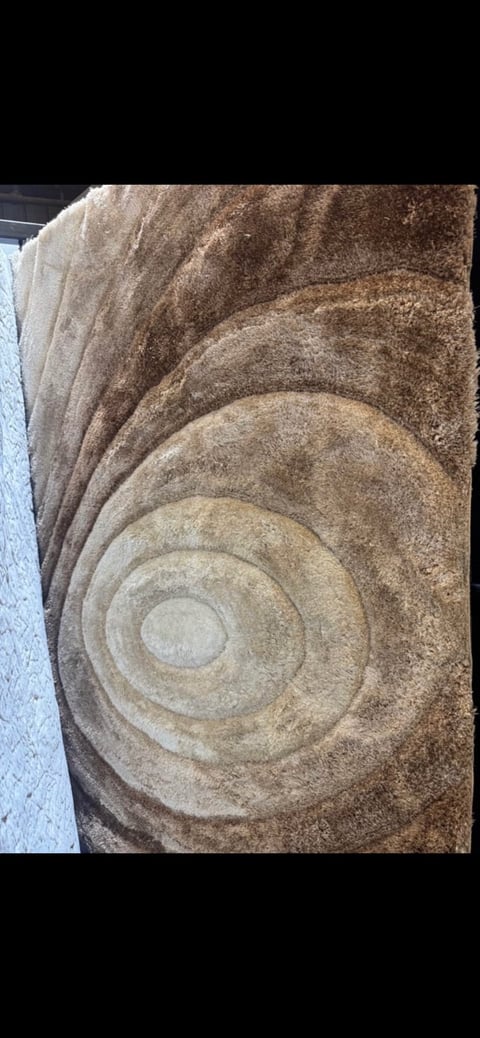 Stone architectural detail with concentric circular carved patterns in beige and brown tones